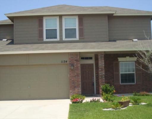 1134 Livermore Street Portland, TX 78374 - Photo 1 of 1 a front view of a house with garden