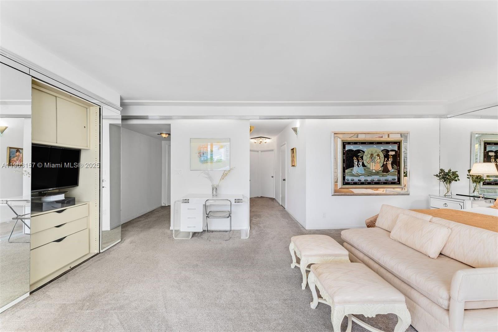 10155 Collins Avenue, Unit 307 Bal Harbour, FL 33154 - Photo 9 of 18 a living room with furniture and a flat screen tv