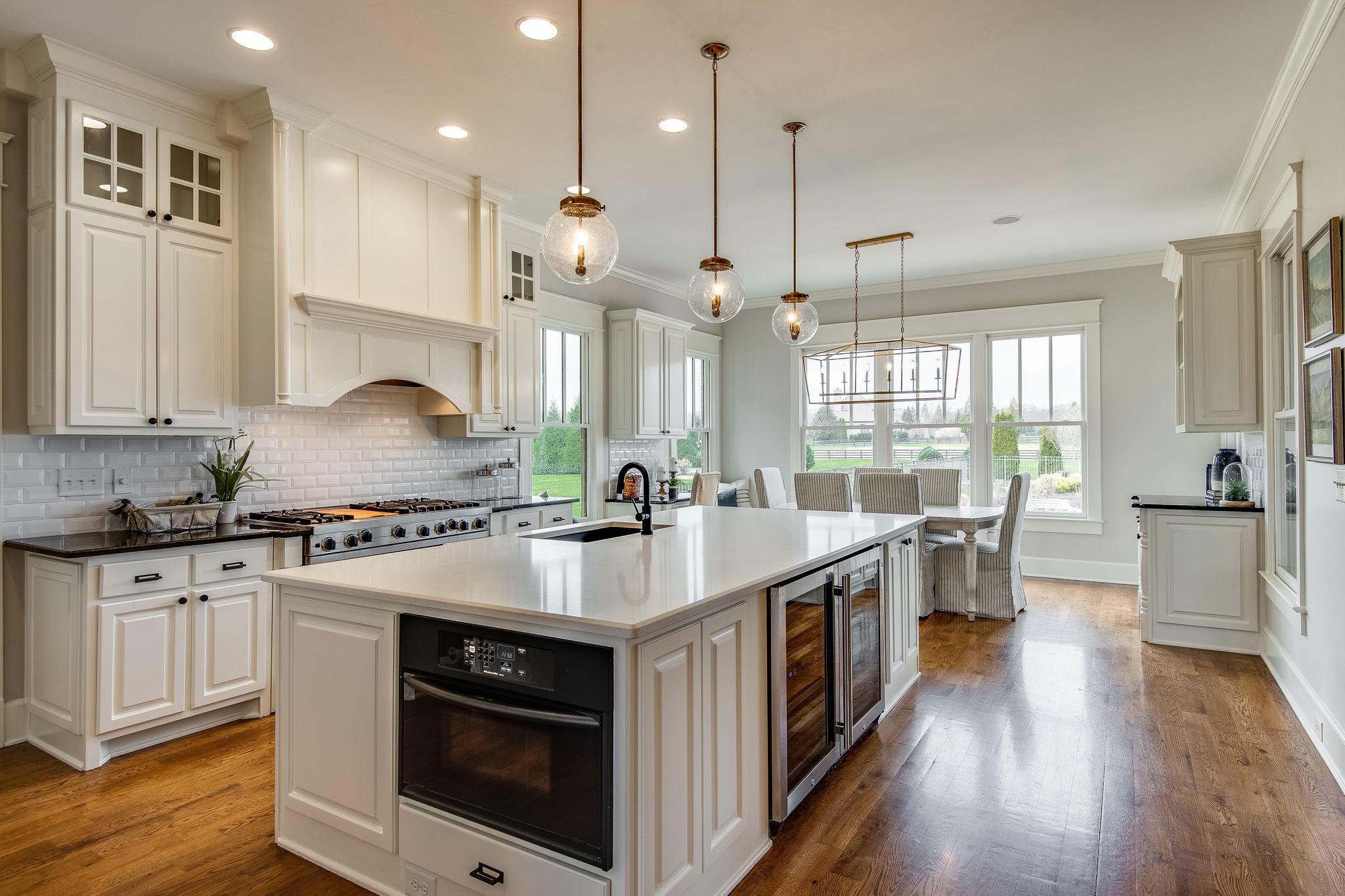4205 Two Rivers Lane Franklin, TN 37069 - Photo 17 of 46 a kitchen with stainless steel appliances granite countertop a stove a sink and a wooden floors