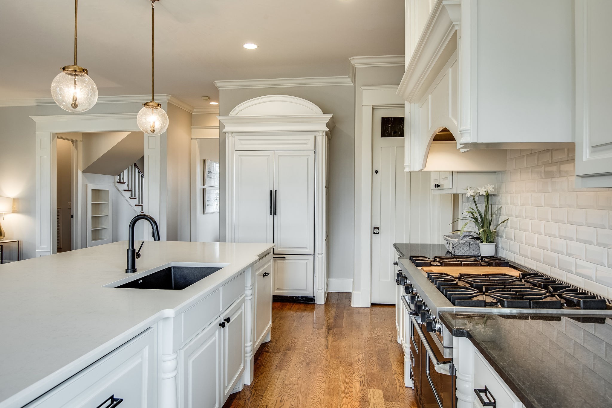 4205 Two Rivers Lane Franklin, TN 37069 - Photo 19 of 46 a kitchen with kitchen island granite countertop a sink a stove and a wooden floors