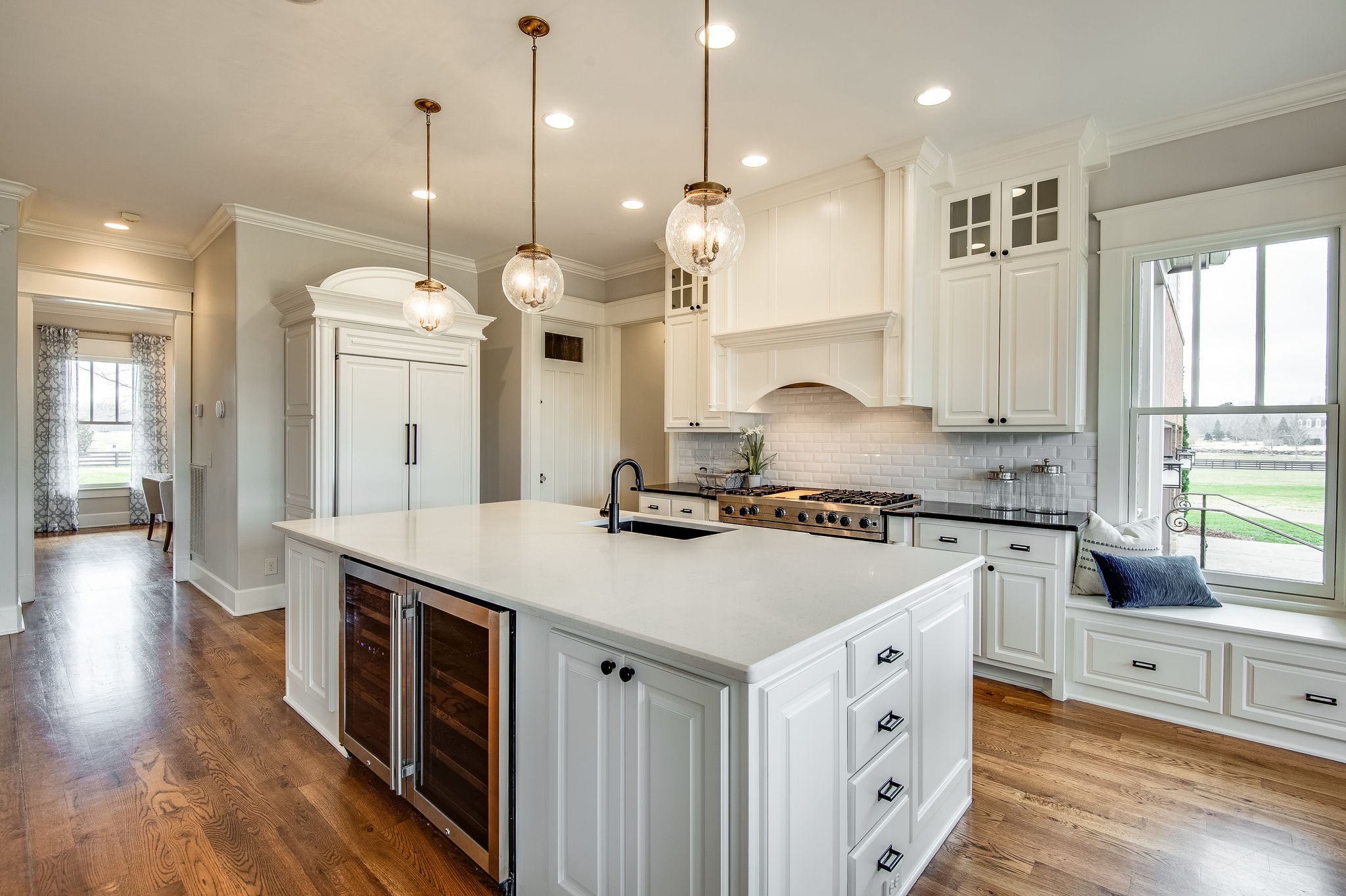 4205 Two Rivers Lane Franklin, TN 37069 - Photo 20 of 46 a kitchen with a stove a sink a center island and windows