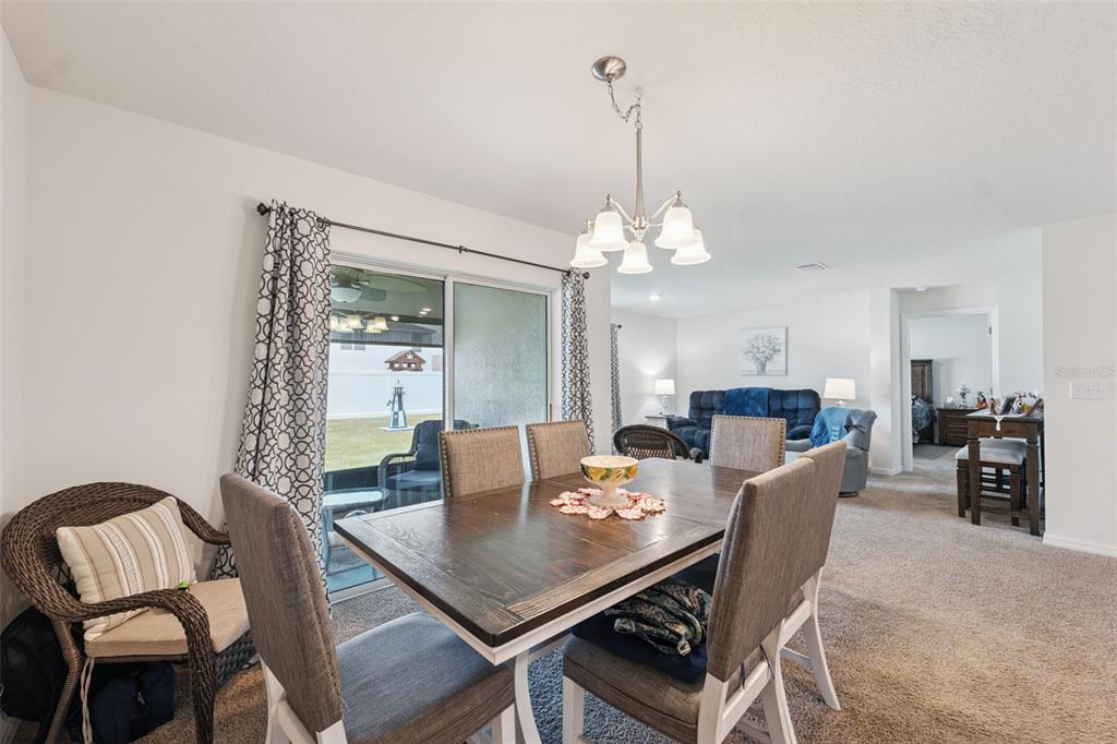 13196 Golden Lime Ave Spring Hill Spring Hill, FL 34609 - Photo 13 of 73 a view of a dining room with furniture and wooden floor