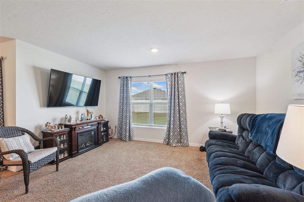 13196 Golden Lime Ave Spring Hill Spring Hill, FL 34609 - Photo 14 of 73 a living room with furniture and a flat screen tv