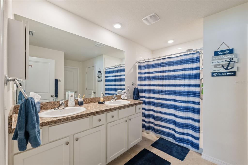 13196 Golden Lime Ave Spring Hill Spring Hill, FL 34609 - Photo 18 of 73 a bathroom with a sink double vanity and a mirror