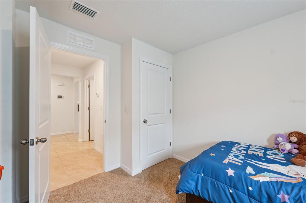 13196 Golden Lime Ave Spring Hill Spring Hill, FL 34609 - Photo 21 of 73 a bedroom with a bed and a cabinets