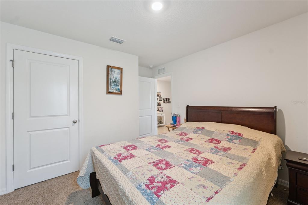 13196 Golden Lime Ave Spring Hill Spring Hill, FL 34609 - Photo 22 of 73 a bedroom with a bed and a cabinets