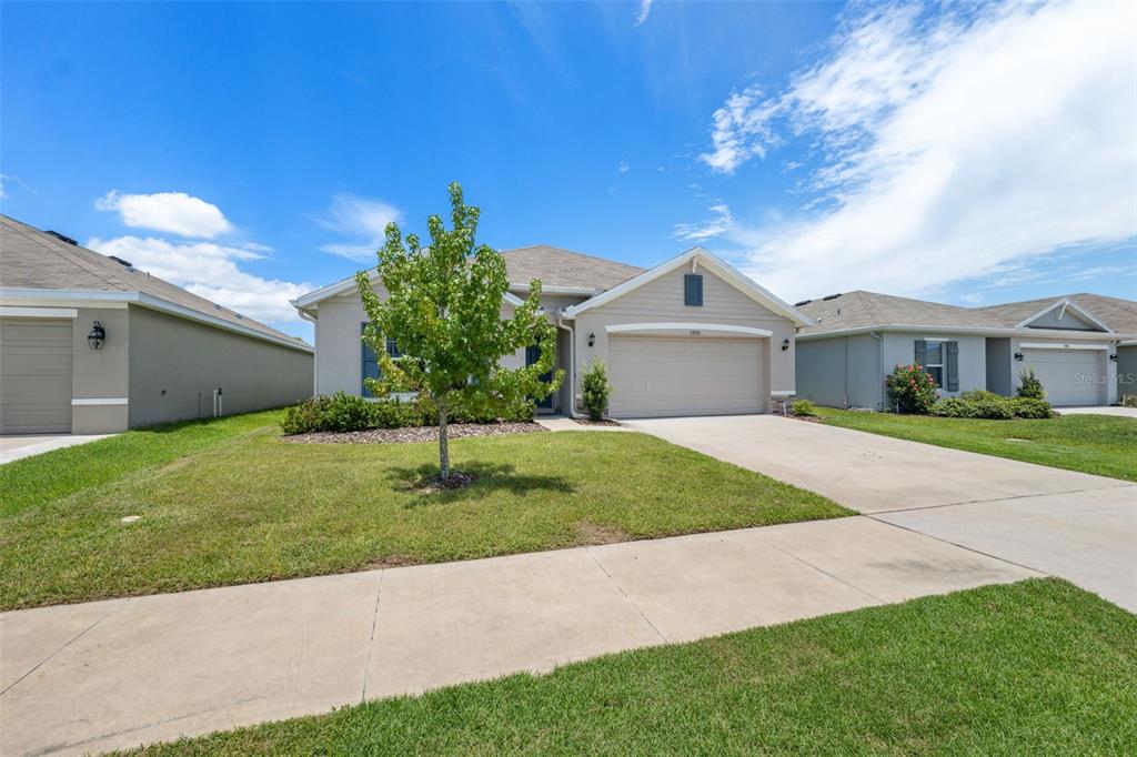 13196 Golden Lime Ave Spring Hill Spring Hill, FL 34609 - Photo 32 of 73 a front view of a house with a garden