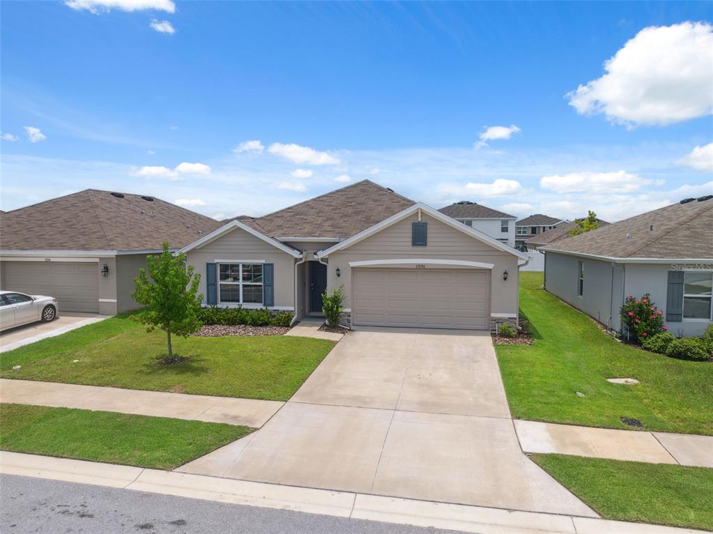 13196 Golden Lime Ave Spring Hill Spring Hill, FL 34609 - Photo 60 of 73 a front view of a house with yard