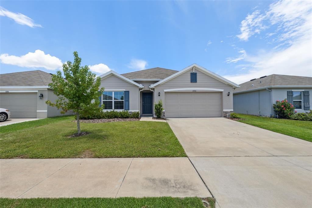 13196 Golden Lime Ave Spring Hill Spring Hill, FL 34609 - Photo 71 of 73 a front view of a house with a garden
