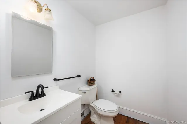 a white toilet sitting next to a bathroom sink
