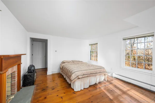 a bedroom with a bed and a large window