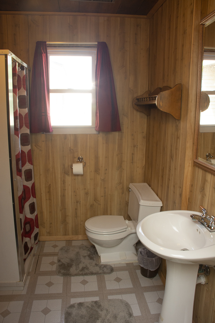 15755 Hillside Road Morrison, IL 61270 - Photo 17 of 26 a bathroom with a toilet a sink and a mirror