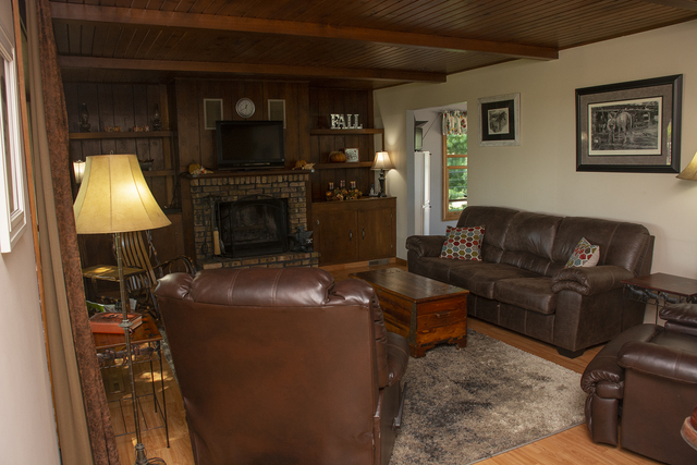 15755 Hillside Road Morrison, IL 61270 - Photo 5 of 26 a living room with furniture a flat screen tv and a fireplace