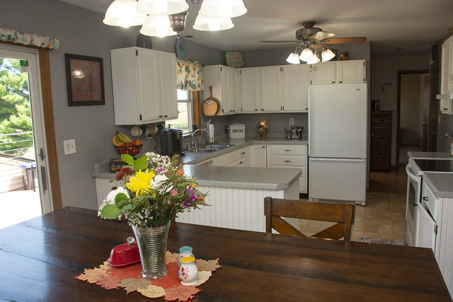 15755 Hillside Road Morrison, IL 61270 - Photo 7 of 26 a kitchen with stainless steel appliances granite countertop a refrigerator dining table and chairs