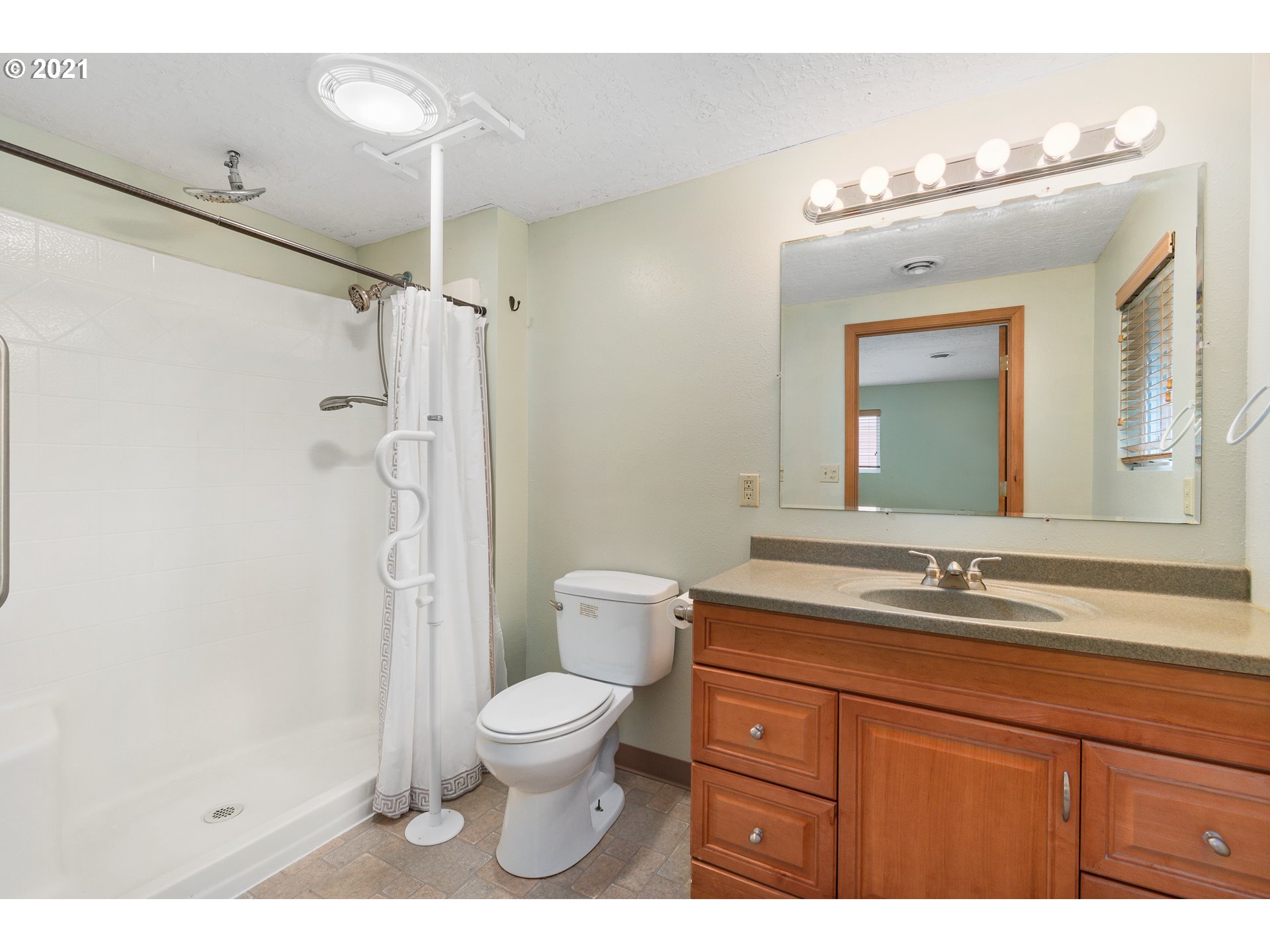 280 Cedar Hills Road Longview, WA 98632 - Photo 17 of 32 a bathroom with a granite countertop sink mirror toilet and shower