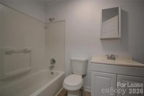 a bathroom with a sink toilet and vanity