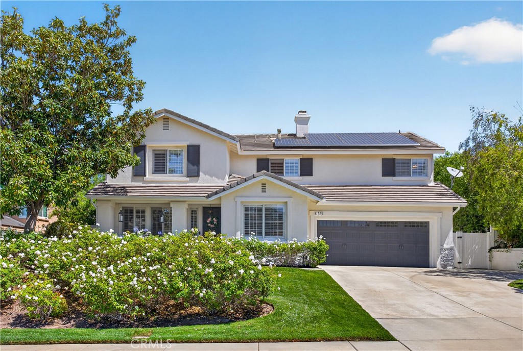 31928 Cercle Chambertin Temecula, CA 92591 - Photo 4 of 74 a front view of a house with a garden and yard