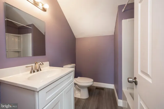 a bathroom with a sink toilet and a mirror