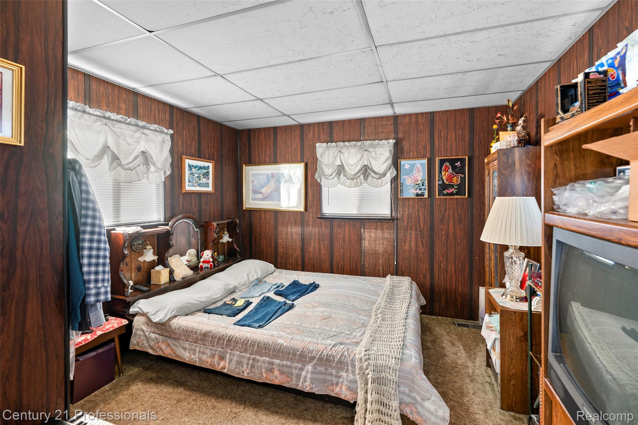 12178 Stephens Road Warren, MI 48089 - Photo 23 of 34 Carpeted bedroom with wooden walls and a paneled ceiling