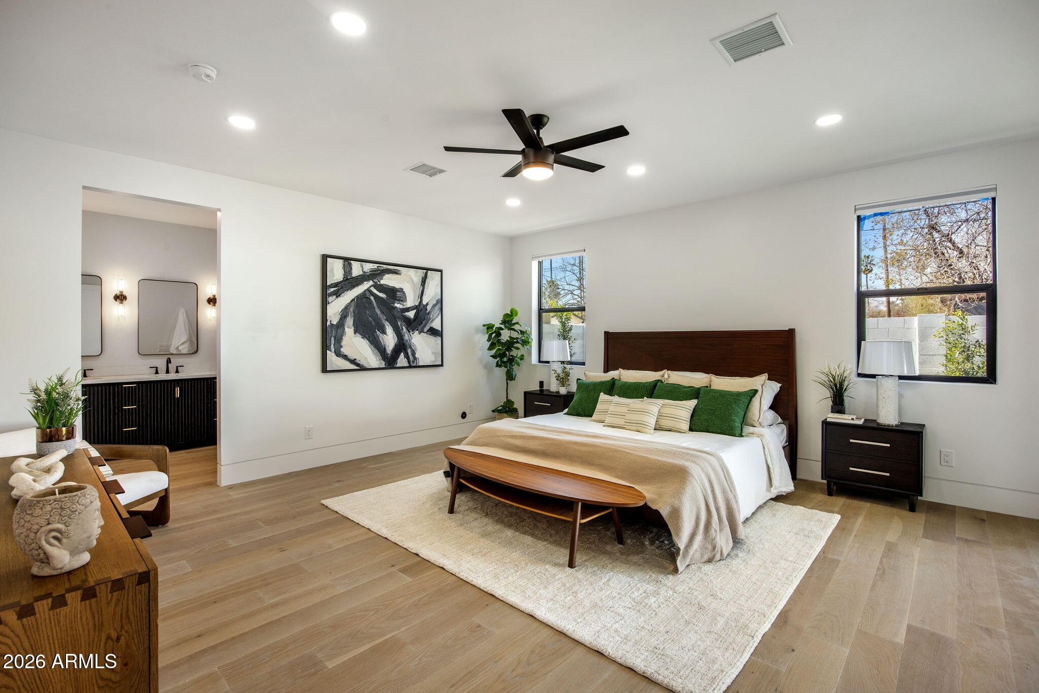 4224 North 35th Place Phoenix, AZ 85018 - Photo 11 of 24 a bedroom with a bed and wooden floor