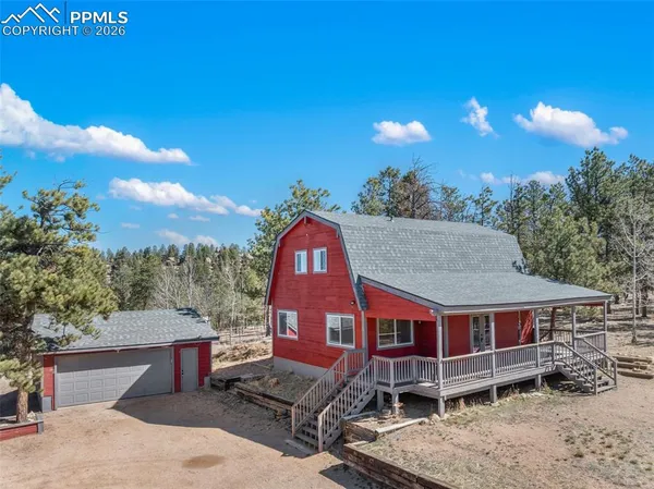 a view of a house with a yard porch and sitting area