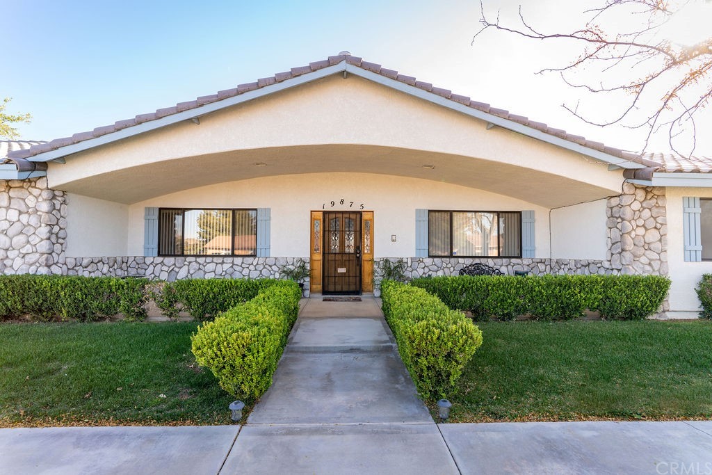 19875 Chaska Road Apple Valley, CA 92307 - Photo 1 of 1 a front view of a house with a yard