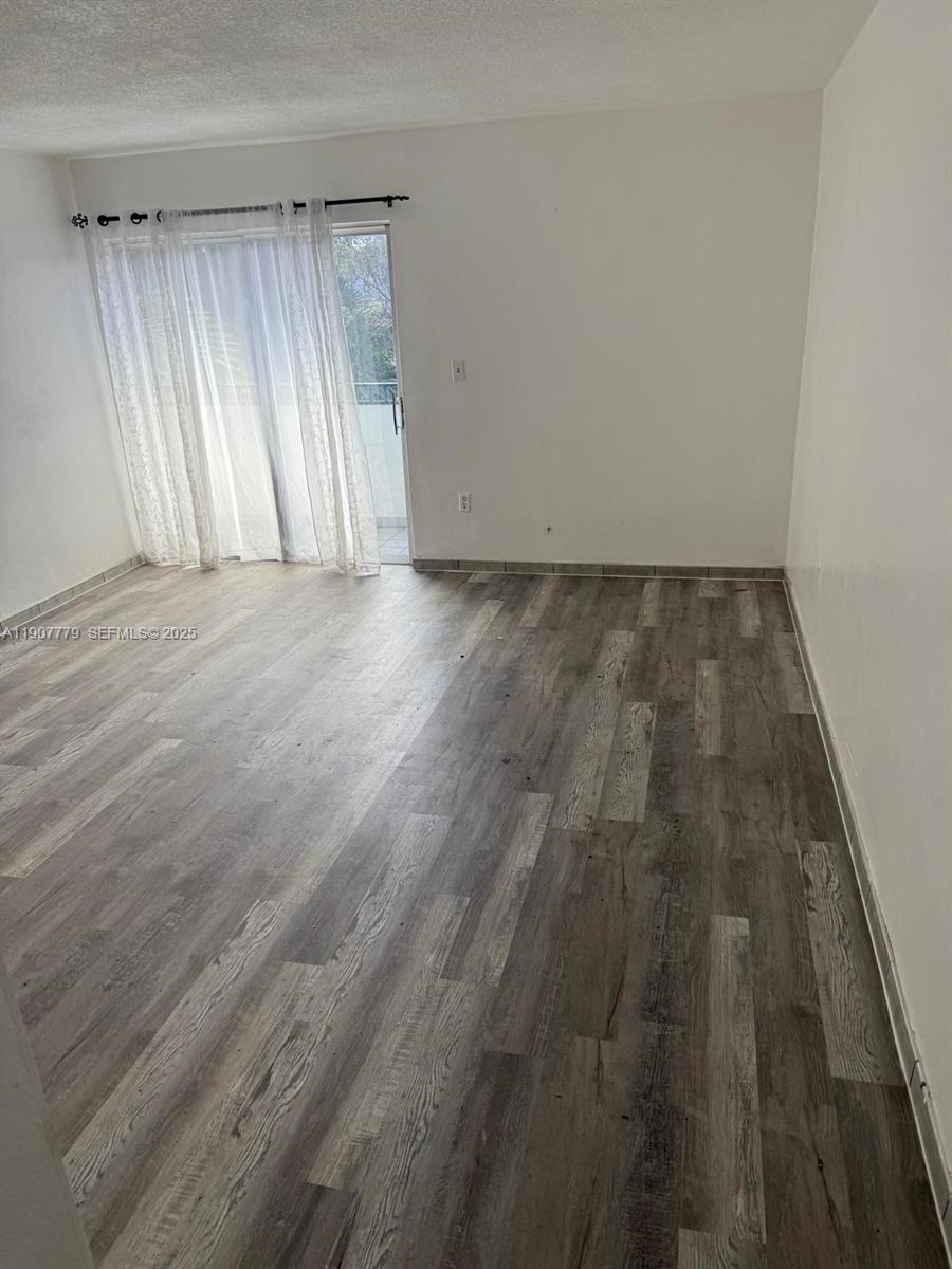 an empty room with wooden floor