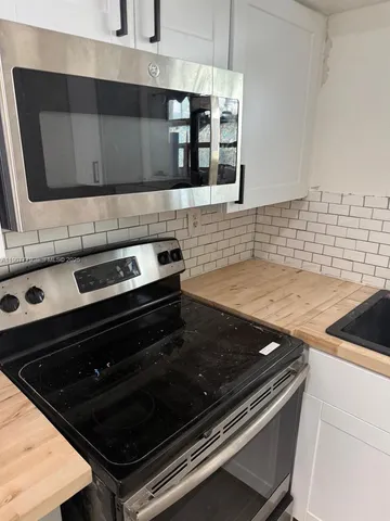a kitchen with a stove and a microwave
