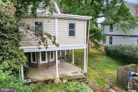 front view of house with a yard and potted plants