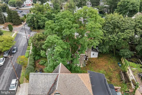 an aerial view of a house with swimming pool and garden
