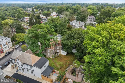 an aerial view of a house with a yard basket ball court and outdoor seating