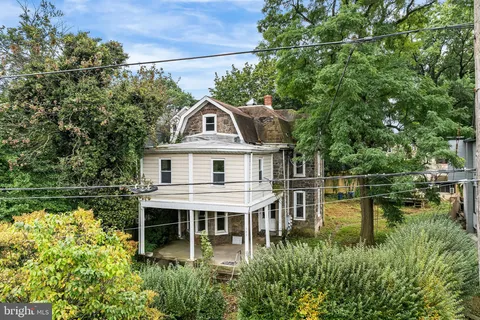 a aerial view of a house with a yard table and chairs