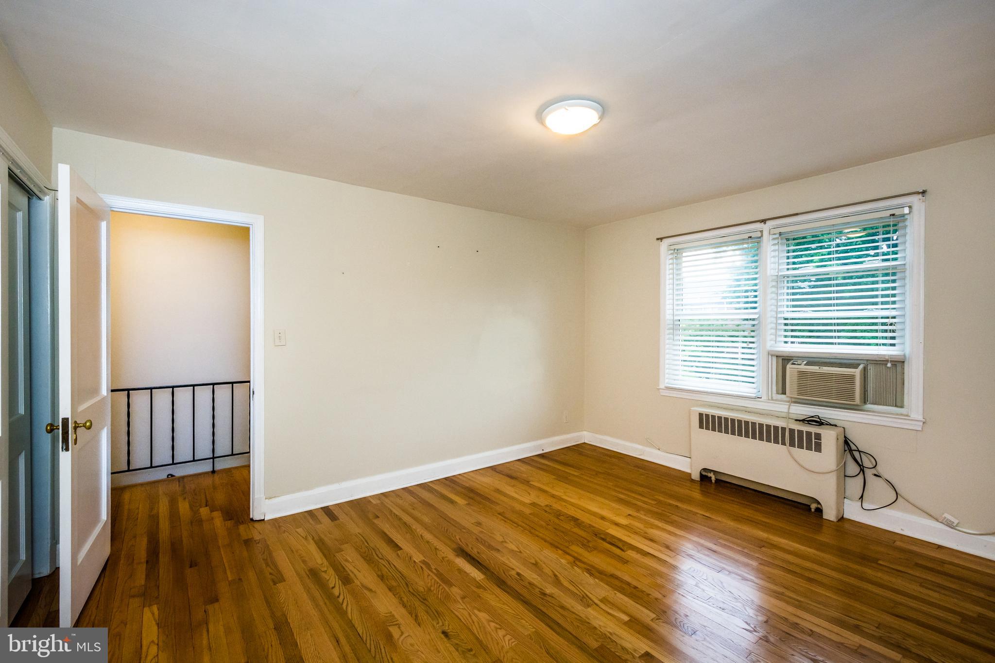 3829 Monterey Road Baltimore, MD 21218 - Photo 19 of 25 a view of a room with wooden floor and windows