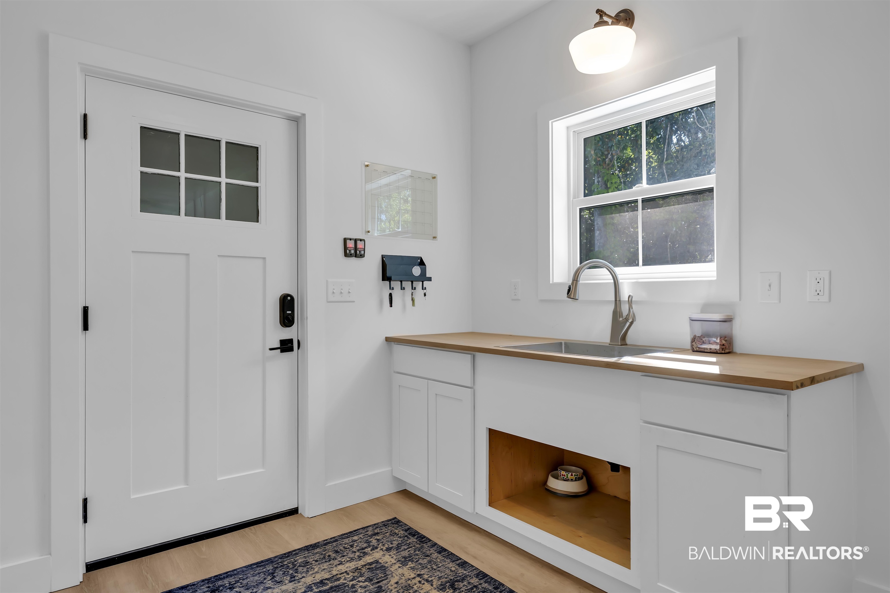 19058 James Road Gulf Shores, AL 36542 - Photo 20 of 49 Doorway to outside with a sink and wood finished floors