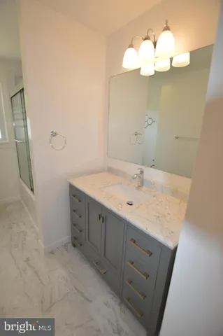 a bathroom with a sink vanity and a mirror