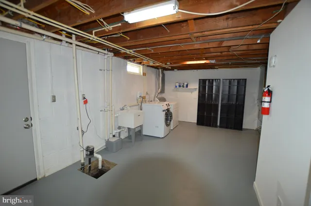 a view of walk in closet with clothes