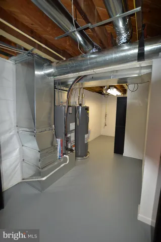 a view of storage and utility room with closet