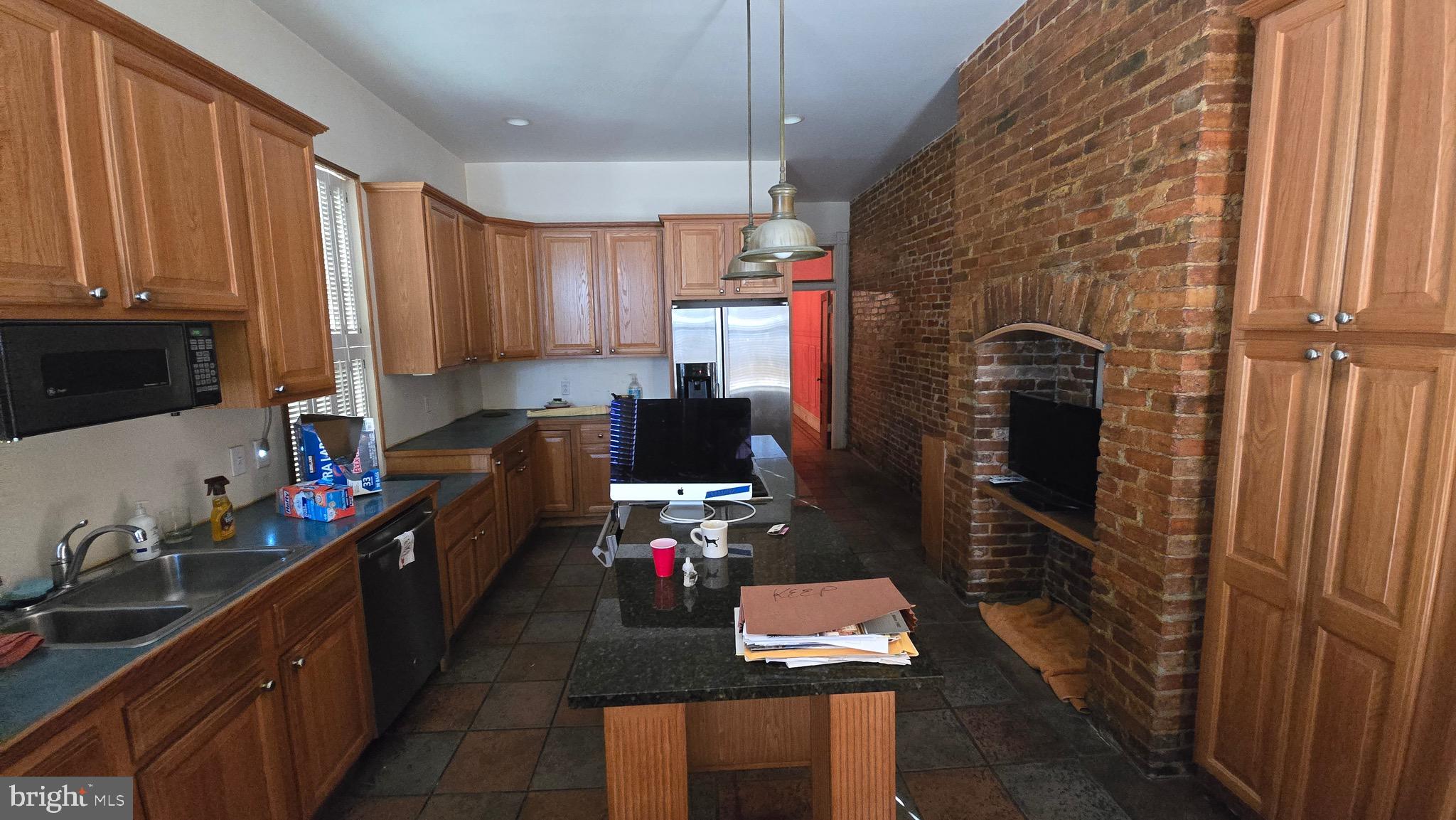 1908 Madison Avenue Baltimore, MD 21217 - Photo 5 of 7 a kitchen with sink refrigerator and cabinets