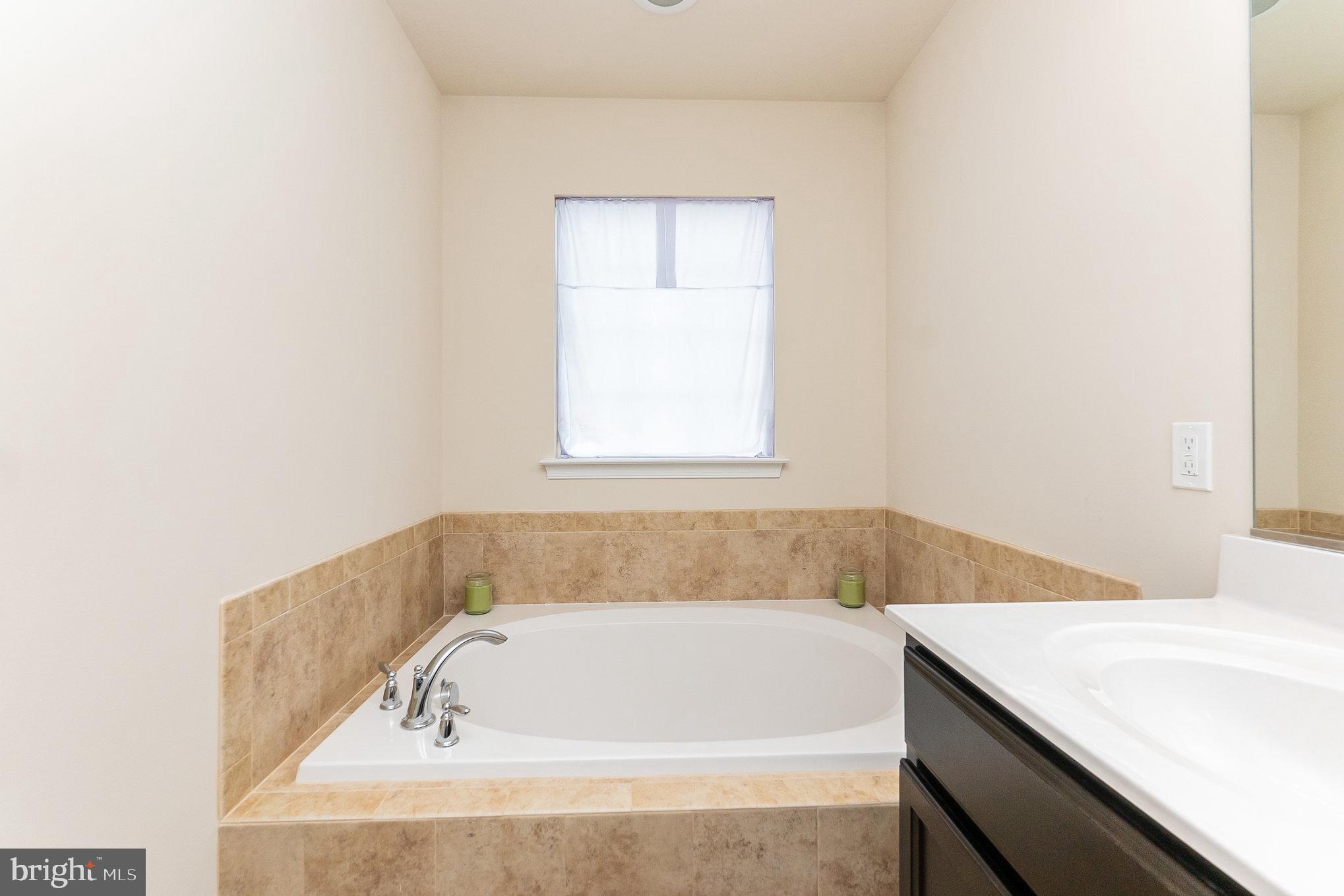 4711 Wensel Road Fredericksburg, VA 22408 - Photo 17 of 33 a bathroom with a bathtub and a window