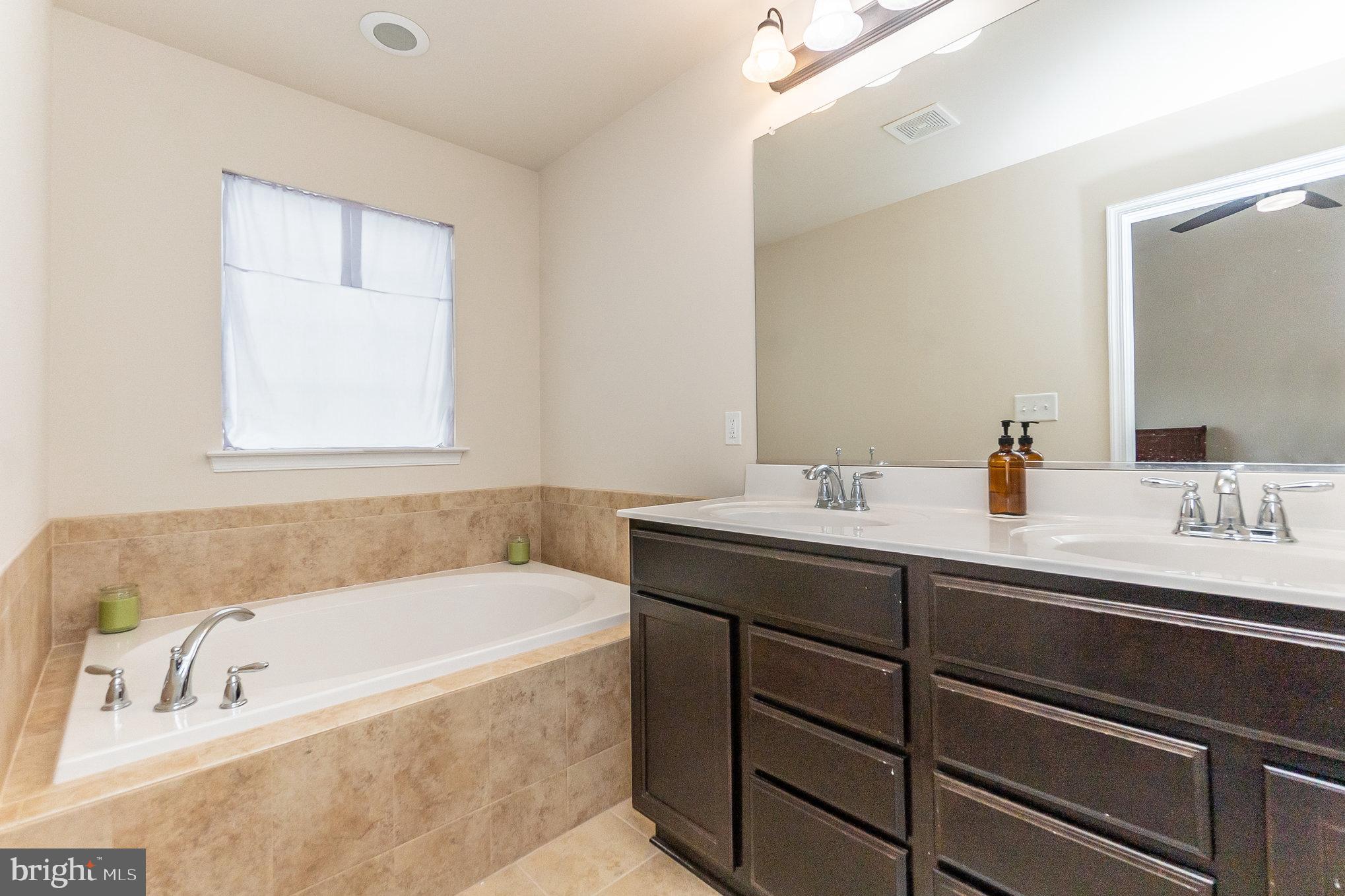 4711 Wensel Road Fredericksburg, VA 22408 - Photo 18 of 33 a bathroom with a tub sink and mirror