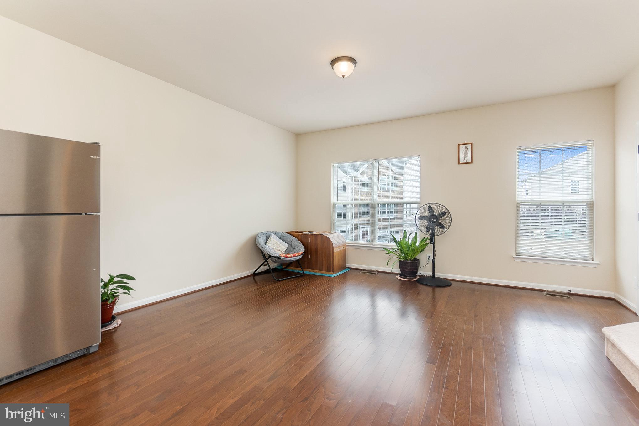 4711 Wensel Road Fredericksburg, VA 22408 - Photo 3 of 33 a view of an empty room with wooden floor and a window
