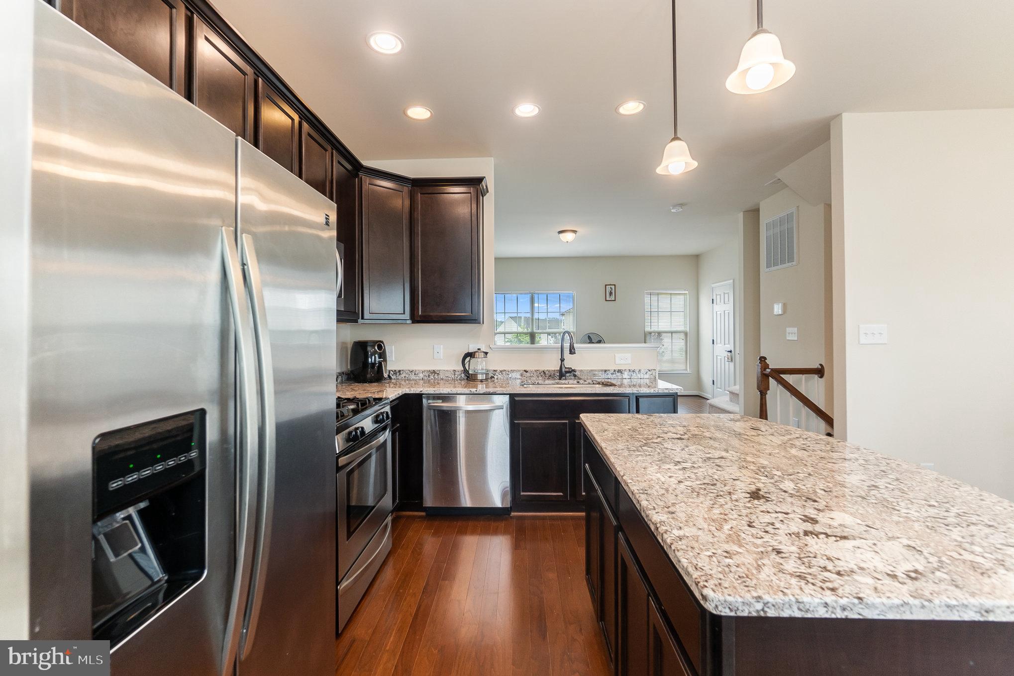 4711 Wensel Road Fredericksburg, VA 22408 - Photo 10 of 33 a kitchen with stainless steel appliances granite countertop a sink stove and refrigerator