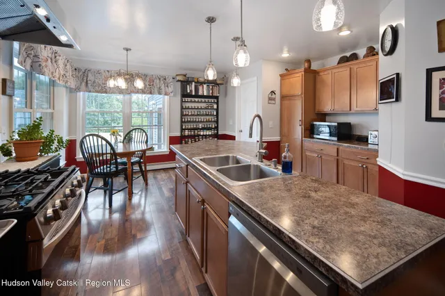 a living room with furniture a bookshelf and a window