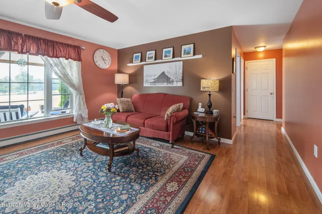 a living room with furniture and kitchen view
