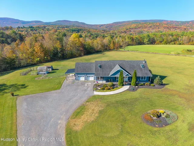 an aerial view of a house with a swimming pool