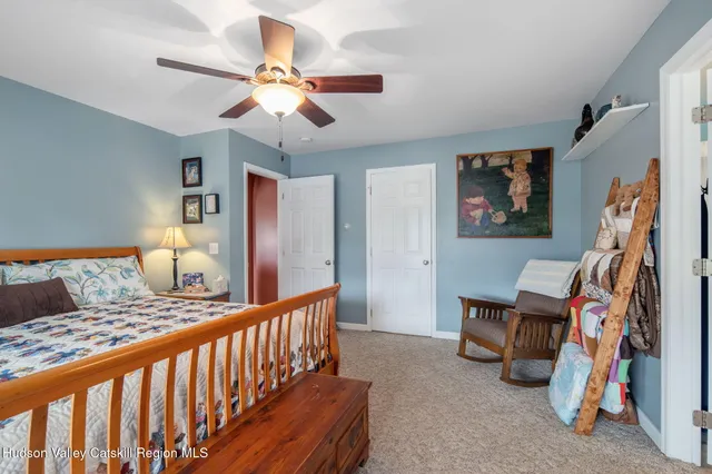 a front view of a house with swimming pool and sitting area