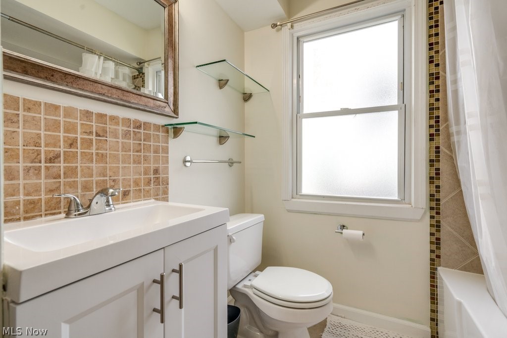 1367 Churchill Road Lyndhurst, OH 44124 - Photo 18 of 30 Bathroom featuring a white vanity with integrated sink, coordinating wall mirror, and square tile backsplash
