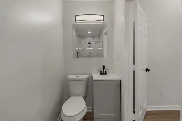 a white toilet sitting next to a bathroom sink