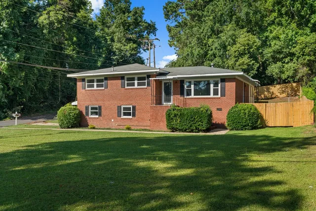 a front view of a house with a garden