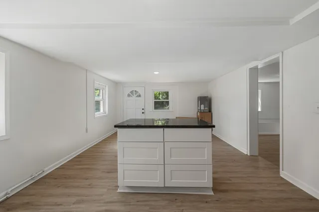 a kitchen with granite countertop a stove and a sink
